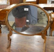 Georgian-style mahogany swing frame oval dressing table mirror raised on splayed legs,