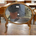 Georgian-style mahogany swing frame oval dressing table mirror raised on splayed legs,