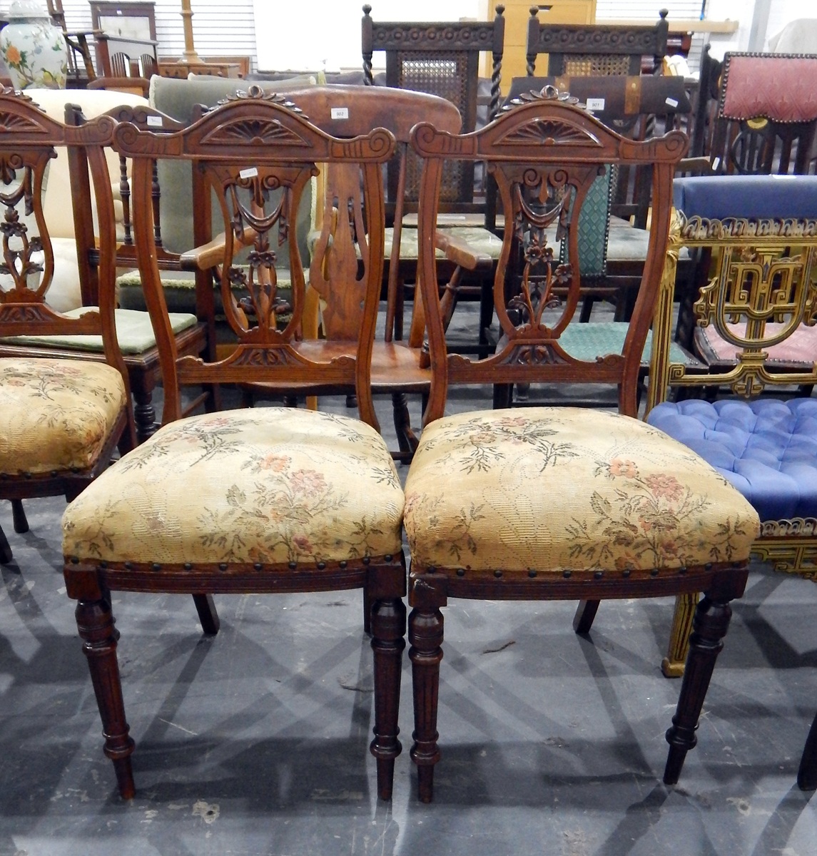 Set of four reproduction stained as mahogany dining chairs with sprung upholstered seats,