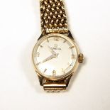 Lady's Omega 9ct gold dress watch with silvered dial and link chain expanding bracelet