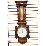 19th century oak-cased aneroid barometer with dentil cornice and temperature gauge flanked by