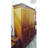 Late 19th/early 20th century faded mahogany two-door wardrobe, each door with four panels,