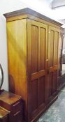 Late 19th/early 20th century faded mahogany two-door wardrobe, each door with four panels,