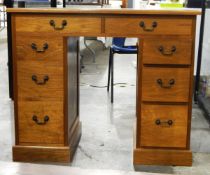 Lady's 20th century line inlaid walnut kneehole desk having an arrangement of eight drawers,