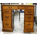 Lady's 20th century line inlaid walnut kneehole desk having an arrangement of eight drawers,