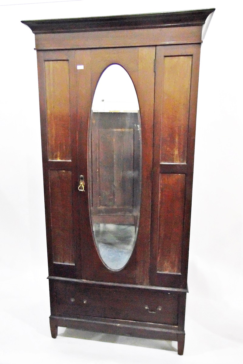 Early 20th century mahogany wardrobe with oval bevel plate mirror door enclosing hanging space with