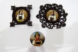 Three porcelain plaques depicting girls in traditional costumes,