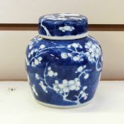 Pair of Chinese porcelain ginger jars and cover with typical prunus blossom decoration, 11cm high,