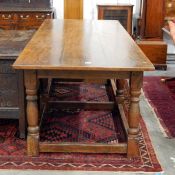 Antique oak refectory-style dining table on six turned supports united by straight stretchers,