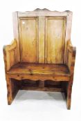 Old pine panel-back seat with downswept arms and solid seat,