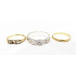18ct gold and three-stone diamond ring (centre stone missing), an 18ct gold wedding ring,