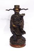 Bronze Chinese robed figure holding a rui sceptre, the base modelled as a dragon, 30cm high,