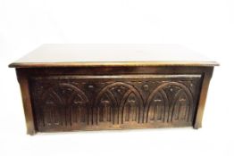 Reproduction stained beech blanket chest with carved panelled front,