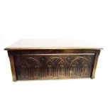 Reproduction stained beech blanket chest with carved panelled front,