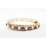 Gold hinged bangle set with 15 alternating round mixed cut amethysts and split pearls,