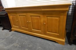 Modern pale chestnut sideboard by Simon Knowles, with three cushion frieze drawers,