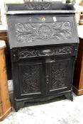 Victorian ebonised and carved bureau, with open shelf top, the fall enclosing pigeon holes,