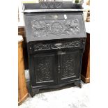 Victorian ebonised and carved bureau, with open shelf top, the fall enclosing pigeon holes,