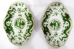 Pair of 19th century dishes of lobed oval form, decorated with dragons in green enamel,