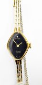 Avia lady's gold plated evening watch with black dial set with a diamond and a link bracelet