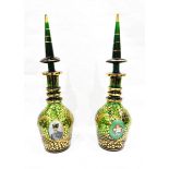 Pair of green ground Bohemian ring neck decanters, having tall tapered stoppers,