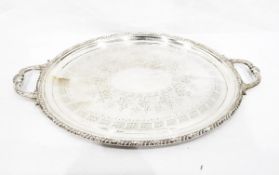 Large silver plated two-handled tray of oval form with engraved decoration and gadrooned and leaf