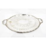 Large silver plated two-handled tray of oval form with engraved decoration and gadrooned and leaf