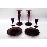 Collection of amethyst glassware to include a set of four baluster-shaped candlesticks,