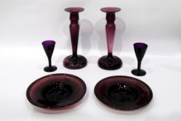 Collection of amethyst glassware to include a set of four baluster-shaped candlesticks,