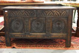 18th century oak coffer with lunette carved frieze over three roundel carved panels and with carved