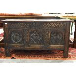 18th century oak coffer with lunette carved frieze over three roundel carved panels and with carved