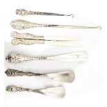 A collection of silver-handled shoe horns, button hooks, glove stretchers, etc.
