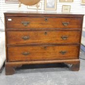 Old oak chest of drawers with cross-banded edged border, three long drawers, raised on bracket feet,