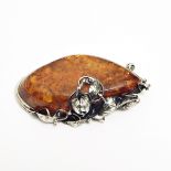 Continental silver-mounted amber brooch,