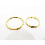 Two gold wedding bands, one unmarked, one indistinctly marked, approx.