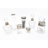 Seven assorted glass dressing table jars with silver mounts,