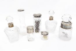 Seven assorted glass dressing table jars with silver mounts,