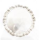 Silver salver by Walker & Hall, Sheffield 1919, of shaped circular form, on three scroll feet,