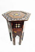 Camel-style stool with leather cushion and an Eastern mother-of-pearl inlaid table of hexagonal