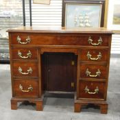 Georgian-style mahogany kneehole desk with moulded edge top,