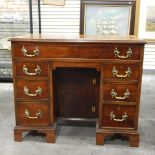 Georgian-style mahogany kneehole desk with moulded edge top,