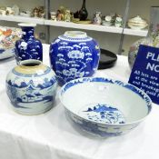 Chinese porcelain bowl with underglaze blue decoration of figure with parasol on bridge to interior,