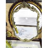 Three mirrors within gilt and decorated moulded frames and a tri-folding dressing table mirror