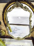 Three mirrors within gilt and decorated moulded frames and a tri-folding dressing table mirror