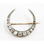 Diamond crescent brooch in white and yellow gold-coloured metal setting,