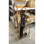 Large Burberry umbrella and two other umbrellas within a bamboo and metal umbrella stand