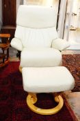 Pair of 'Stressless' cream leather reclining armchairs on revolving circular bases with matching