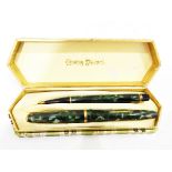 Conway Stewart fountain pen and propelling pencil in mottled green case,
