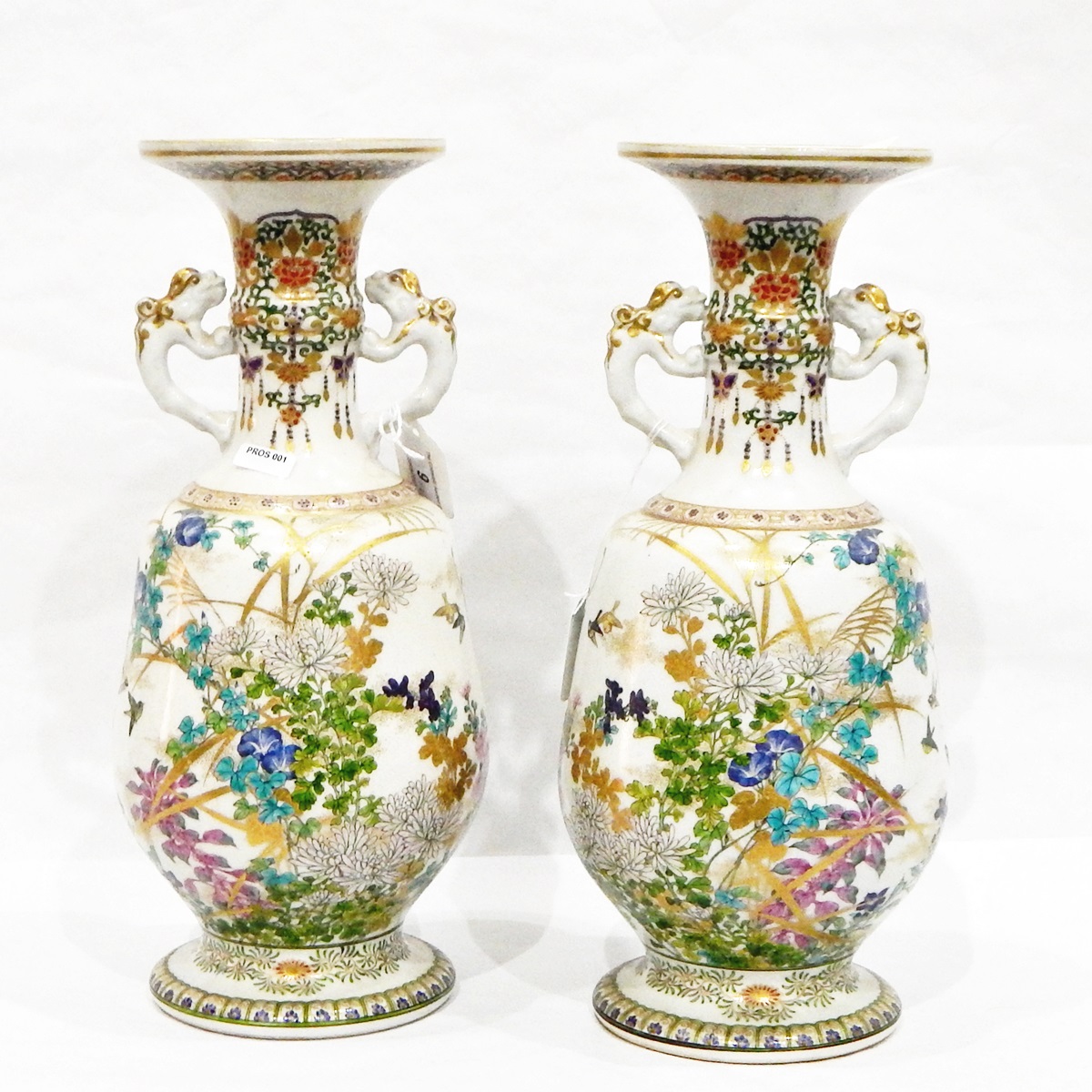 Pair of Japanese Meiji period porcelain vases, probably Kinkozan, each footed,