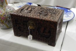 Camphorwood box, the hinged cover and sides carved in relief with figures and boats,